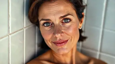 42-year-old model (toned body) (bright light gray eyes) ultra-sharp iris detail, subtle reflections, moist tear line, natural lashes, hyper-detailed face, natural skin pores, soft cheek shadows, high-resolution lash texture, realistic light on the bridge of the nose, subtle smile lines, photo realistic shading, moist full lips, soft natural sheen, deep rose color, subtle skin texture, visible lip folds, realistic light reflection, photo realistic shadows, visible scleral veins, photo realistic shadows, short wavy dark brown hair, soft skin texture, realistic nipple detail, anatomically correct placement, subtle interplay of light and shadow, woman leaning against bathroom tiles, soft cinematic lighting, Hasselblad H6D-100c, lens 85mm f/1.2, ultra-detailed skin, (realistic anatomy)