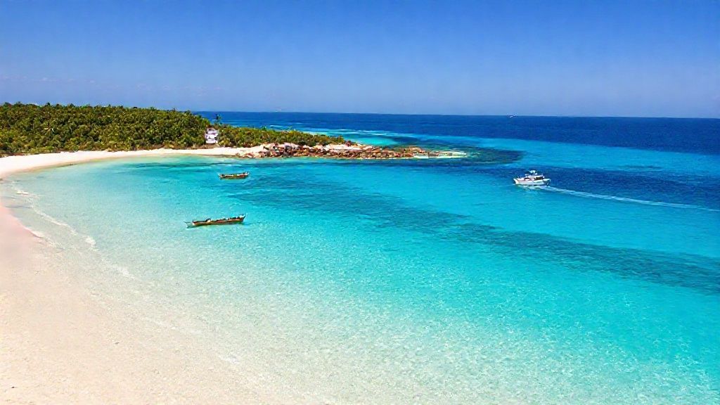 In the foreground lies an exceptionally clear ocean, transitioning from turquoise to deep blue. The sea is so clear that even shallow patches of sand and rocky structures can be seen through the water. The shoreline, shaped like a peninsula/ledge with a thin line of white sand extending into the sea, has created a natural beach language. Beach and Land The beach is covered with pristine white, soft, fine-grained sand. Several wooden fishing boats and boats of various sizes are moored near the shore. As you move inland, a densely verdant, wooded area opens up. Tropical trees and shrubs add a natural richness to the view. Behind the trees, a more inland settlement, small structures, and a few larger buildings can be discerned. Sea Movement Across the vast ocean: Several small boats, Motorboats leaving a light trail on the water, A small sailboat-like canoe-like vessel is seen moving in the wind on the left. Atmosphere and Light A time when the sun is nearing sunset or sunrise; slightly soft, golden yellow tones. The sky is a light pastel shade, cloudless or slightly overcast. The overall photo conveys the calm, warm, and peaceful feeling of a tropical island vacation.
