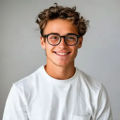 A young man in white clothes, wearing glasses, smiling and looking at the camera, a beardless young man standing upright.